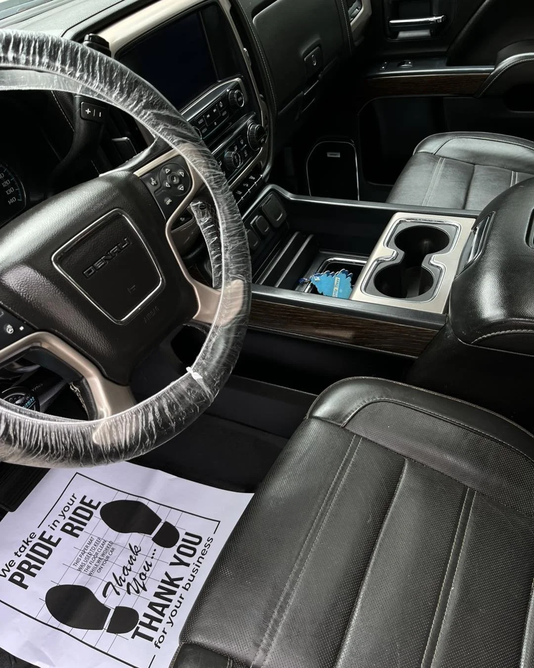 Three white semi-trucks parked in front of an industrial building with tanks and a PepsiCo sign, under a clear blue sky.