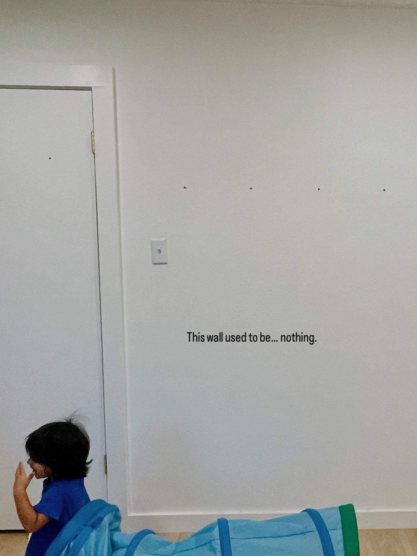 Not every play space needs a full room.
Sometimes, one wall is enough to change how kids move through their day.

This space was designed to support climbing, spinning, shooting hoops &mdash; and growing into new abilities over time.

Thoughtful desi