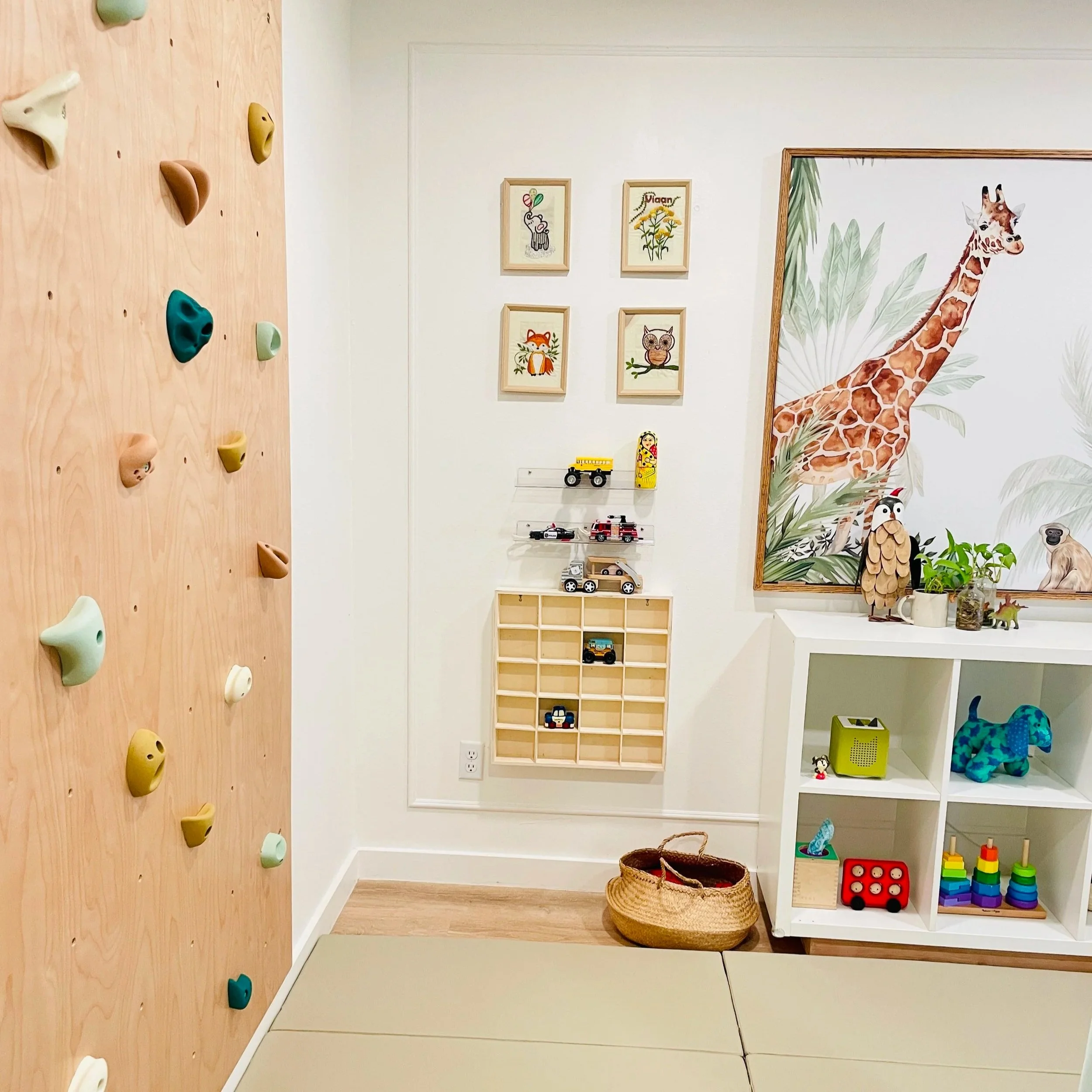 Climbing wall in an animal and jungle themed playroom