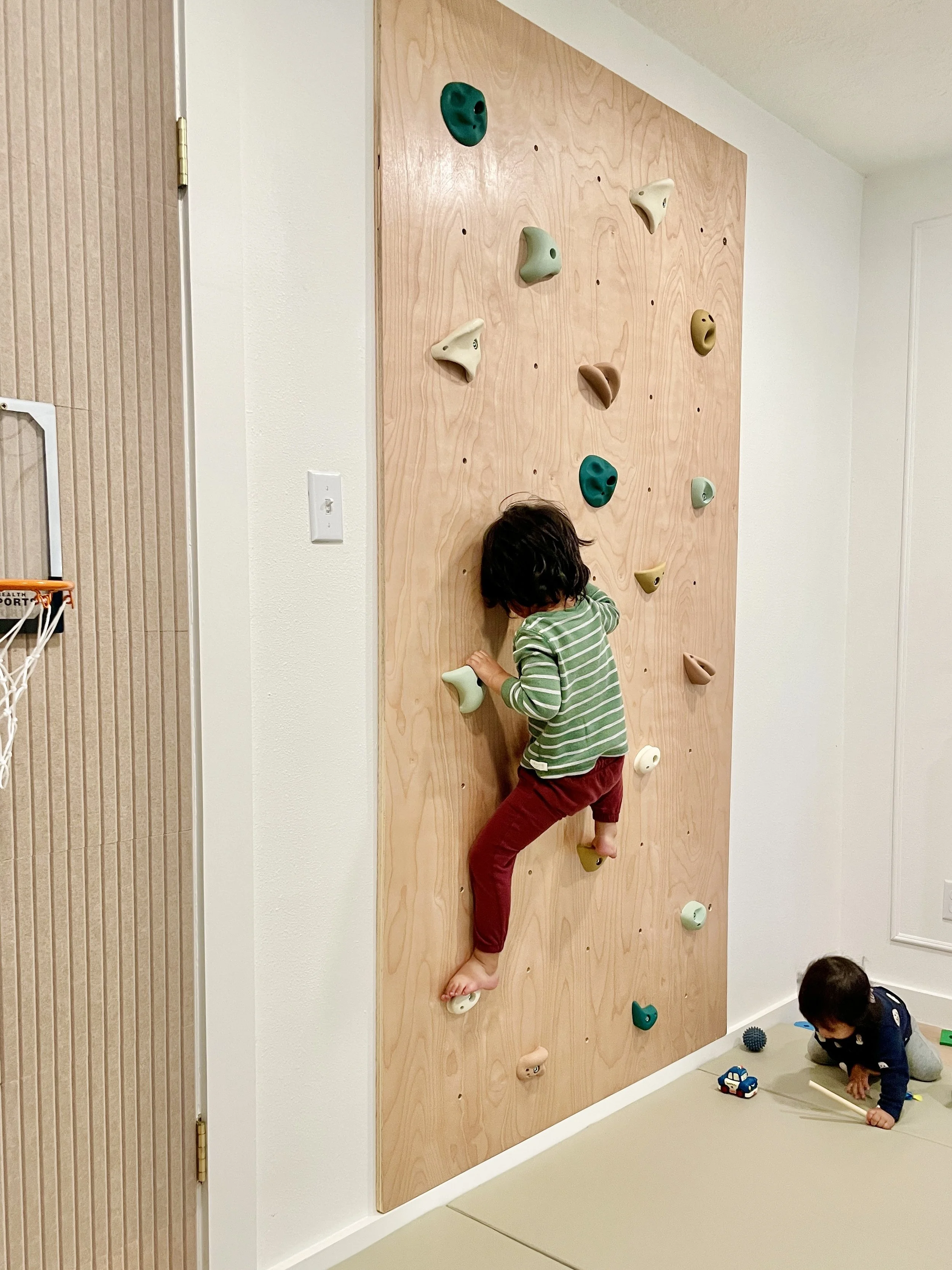 Child scaling a climbing wall