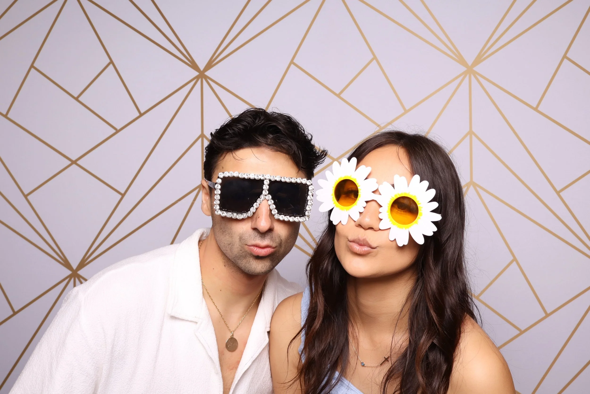 Couple posing in colour photo booth at Melbourne milestone birthday celebration