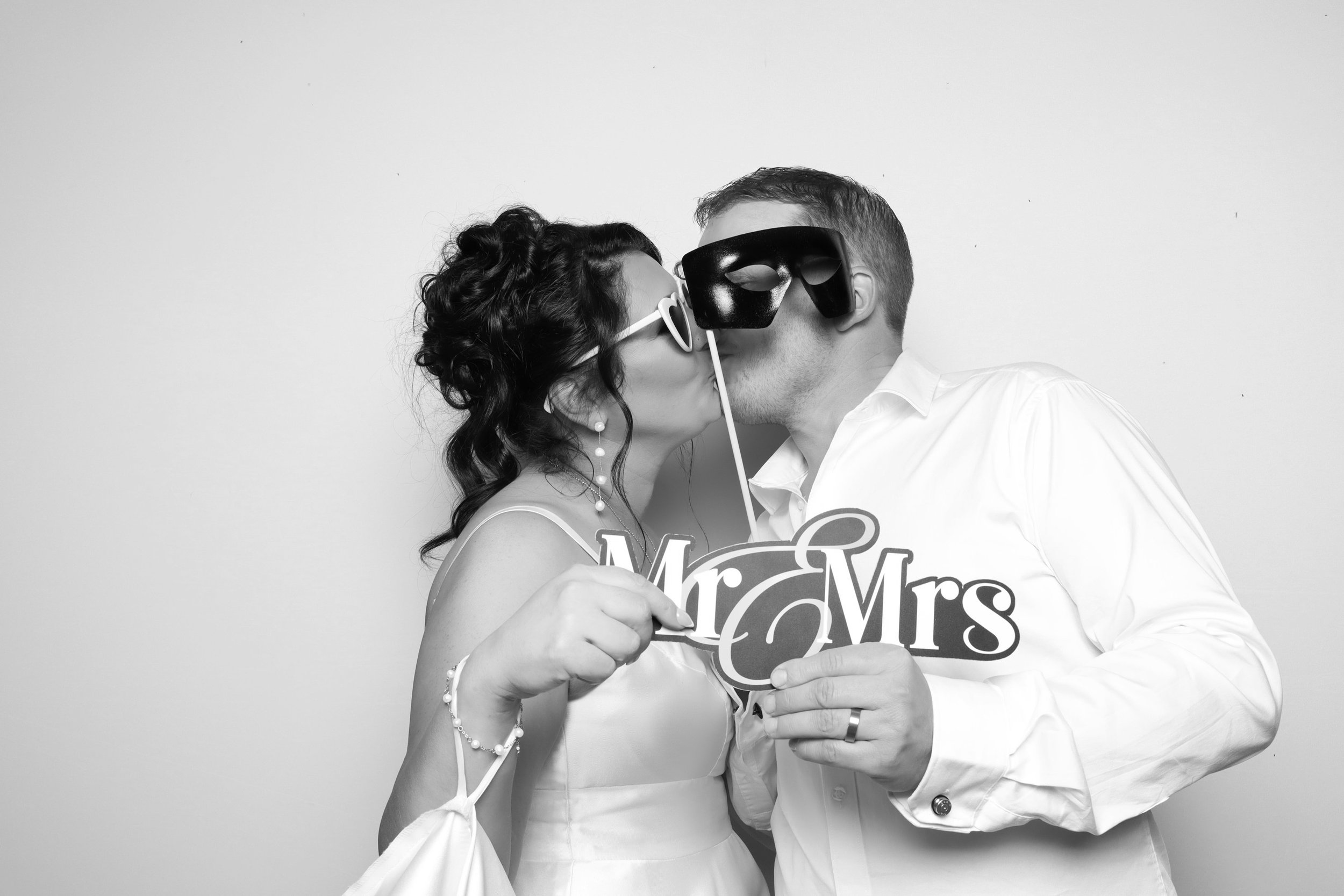 Bride and groom in black and white photo booth at Melbourne wedding