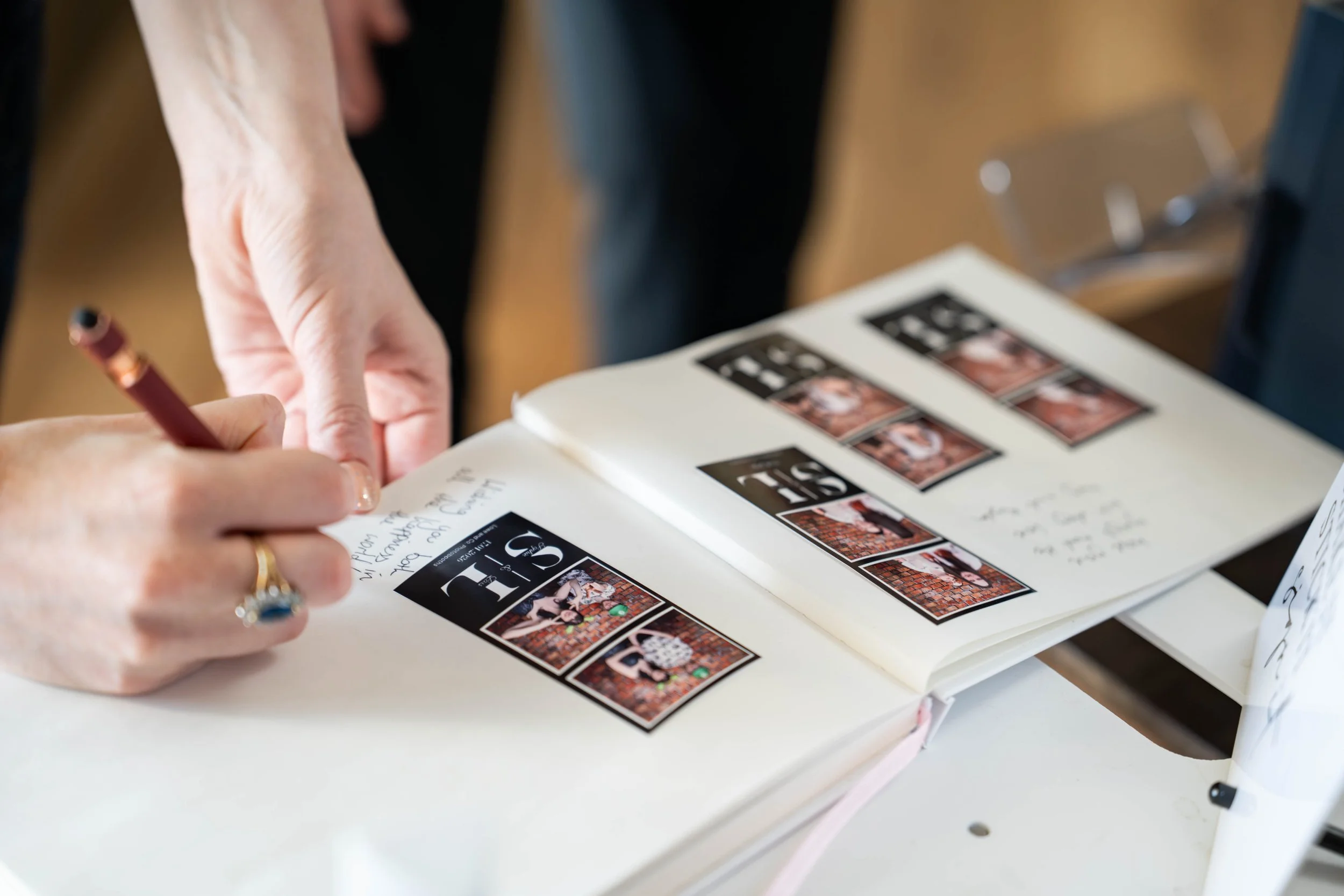 Guest signing a photobooth guest book at a wedding in Melbourne