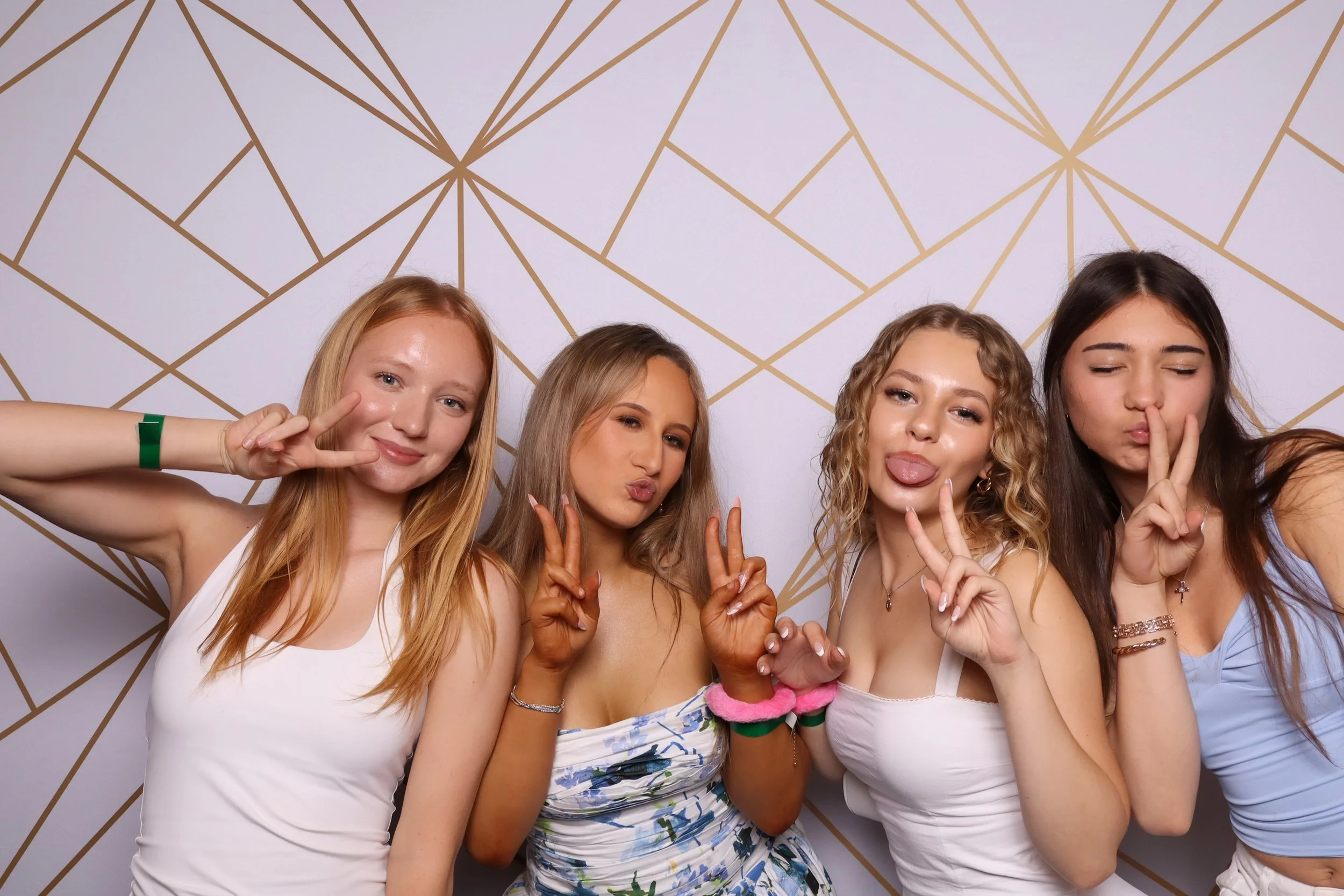 Friends posing in colour photo booth at Melbourne milestone birthday celebration