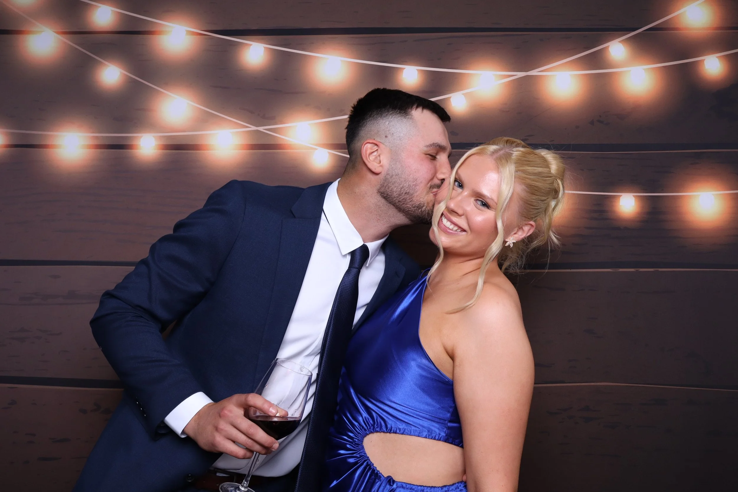 Couple in bright colour photo booth at Melbourne wedding venue