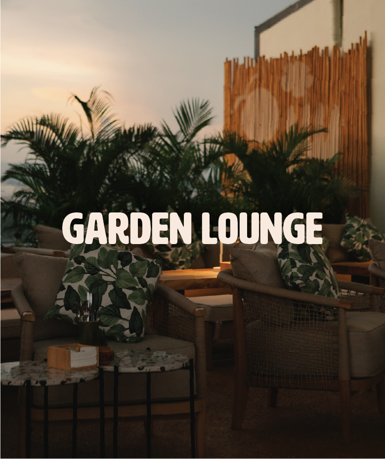 Indoor garden lounge with wicker chairs, tropical plants, and decorative pillows with leaf prints at sunset, with the text 'GARDEN LOUNGE' overlayed.
