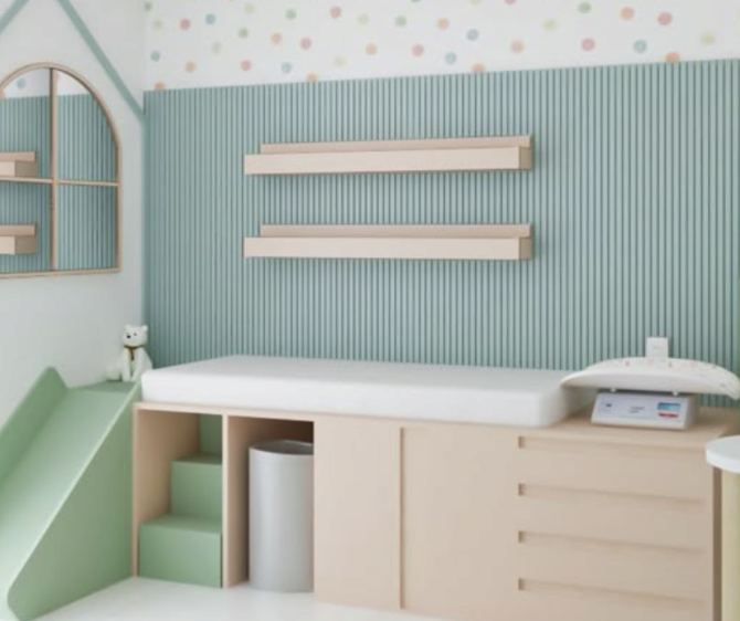 A pastel-colored children's examination room with a medical scale, a small teddy bear, and decorative wall shelves.