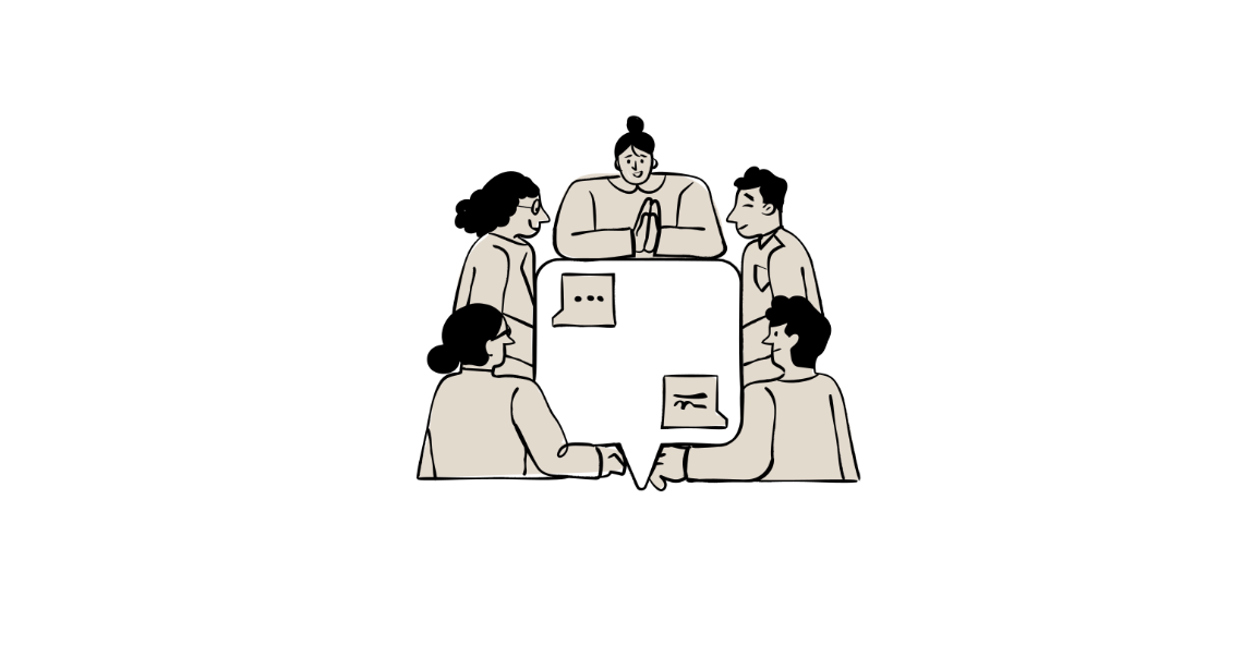 A group of six diverse people sitting around a table having a discussion in a meeting room.