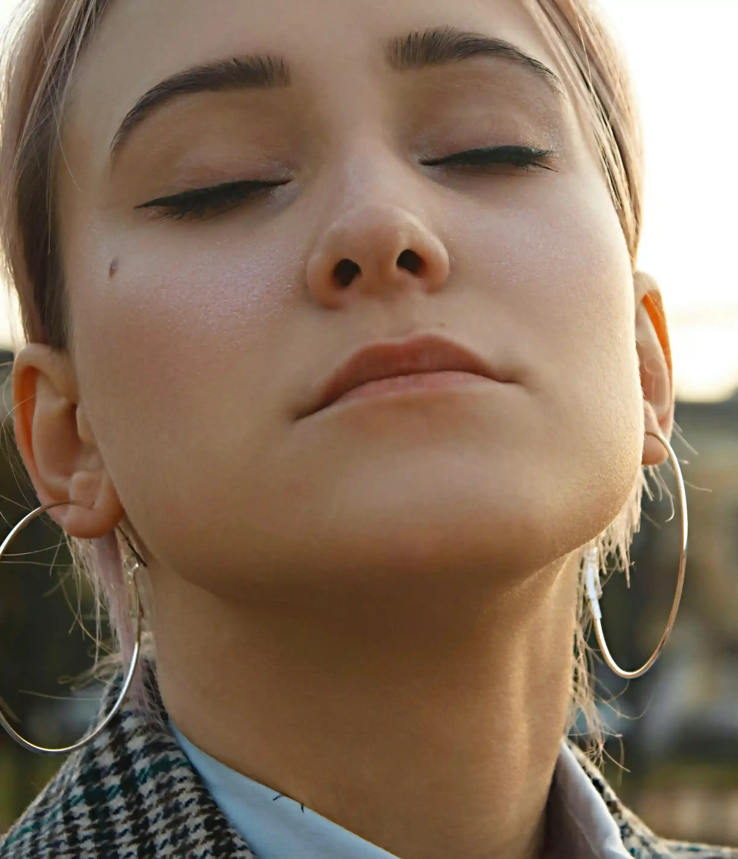 Close-up profile of woman with soft, even skin tone symbolizing hydrodermabrasion facial benefits