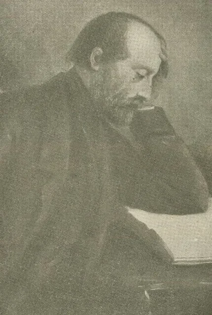 Giuseppe Mazzini with a beard and long hair, sitting with his head resting on his hand, looking downward.