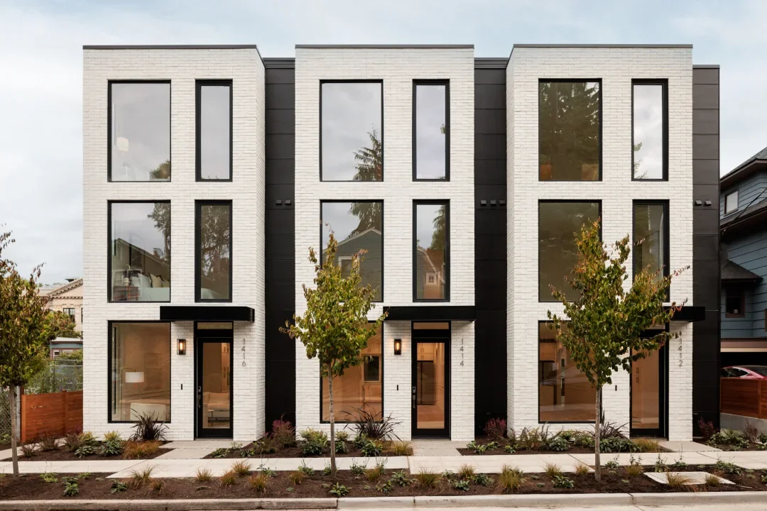 Townhomes are multi-level residential properties that shared adjacent walls but have separate entrances, often featuring multiple stories and attached garages.