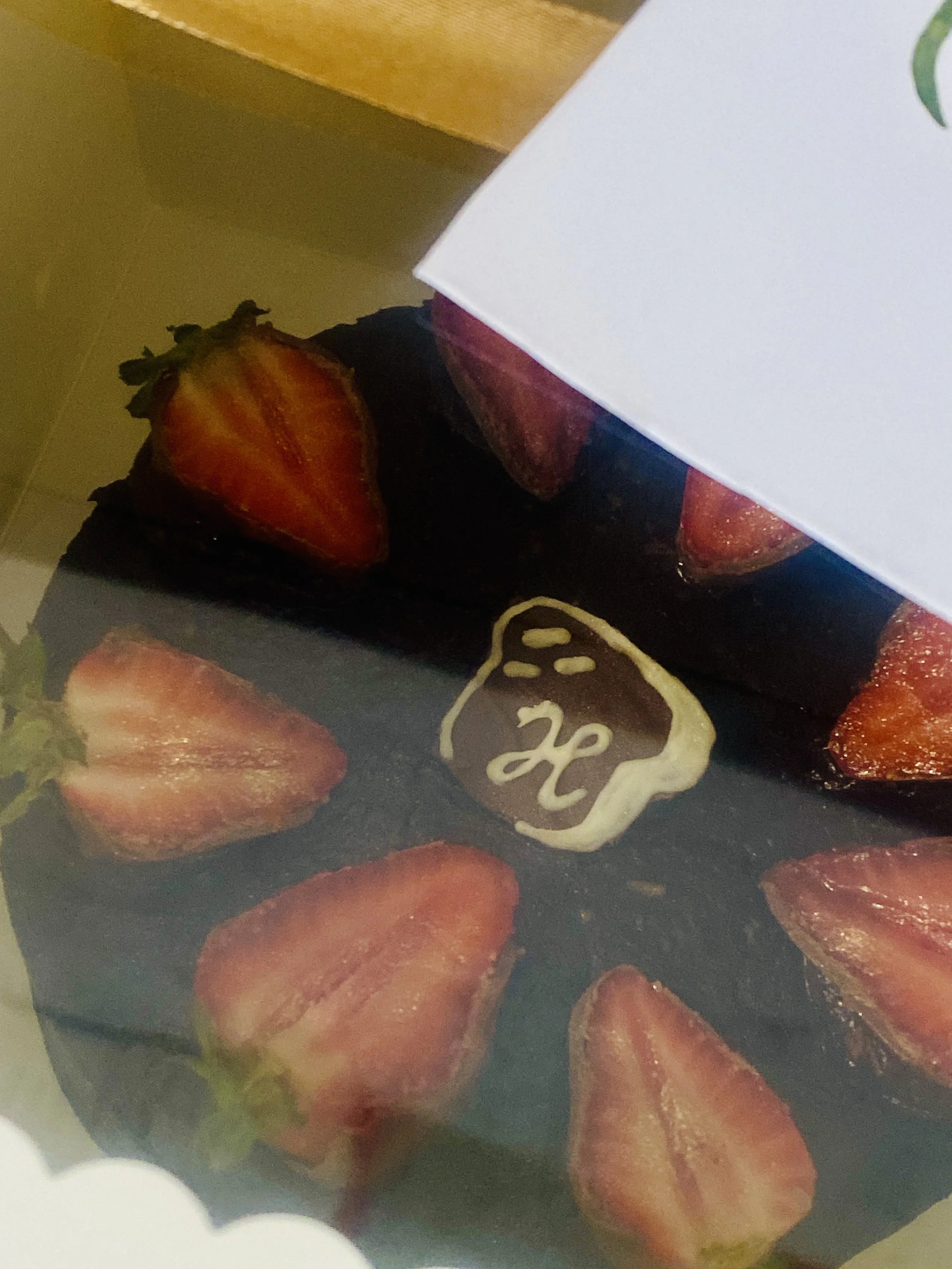 Close-up of a box of sliced strawberries with a sticker that says 12.