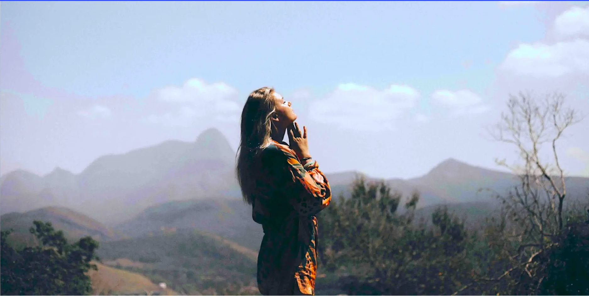 Woman looking over mountains for Zoom event on affirmations.