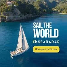 A sailboat on calm blue water with trees along the shoreline, promoting sailing trips with the text 'Sail the World Seadard' and a call-to-action button saying 'Book your yacht now'.
