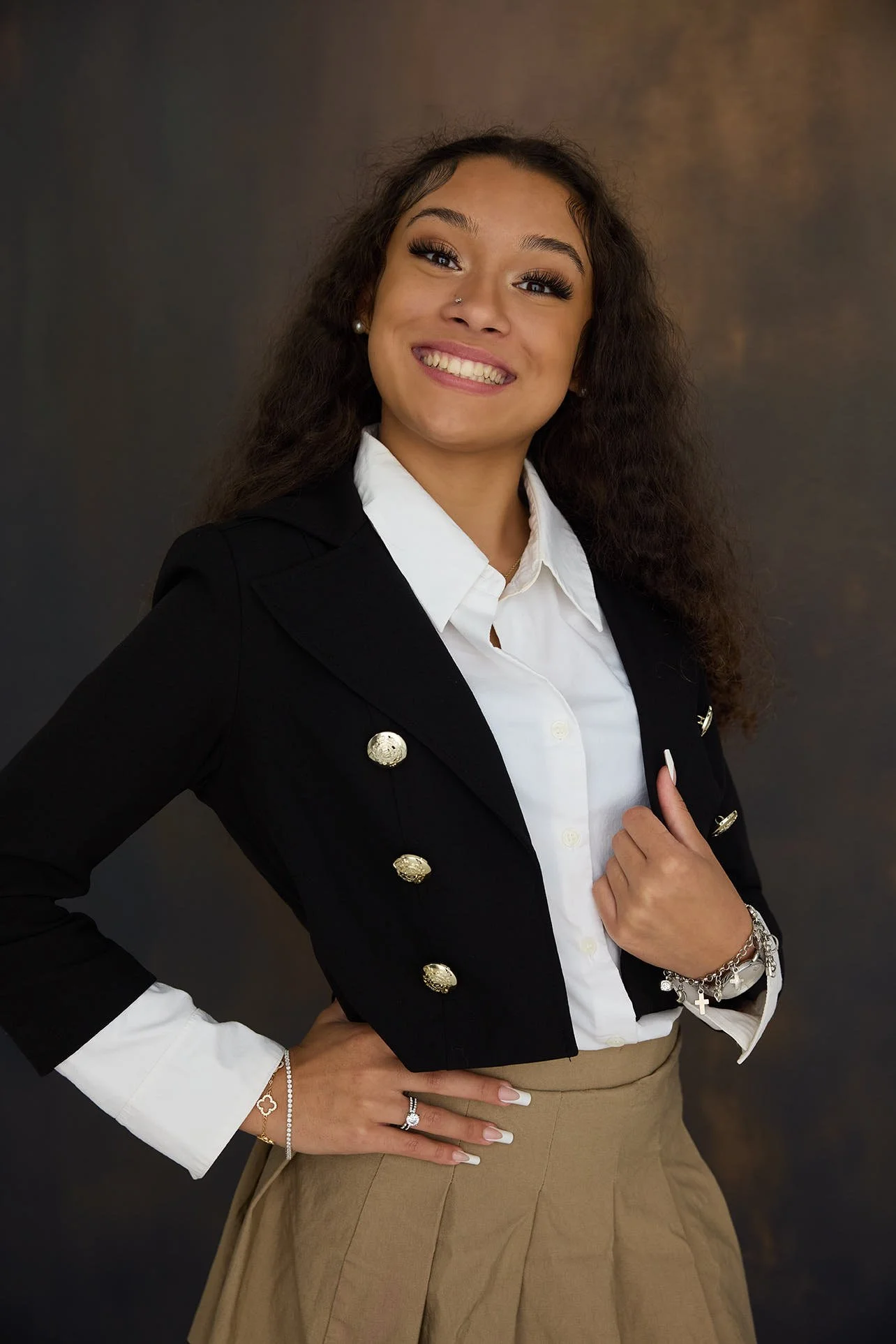 Girl posing for headshot on textured background.