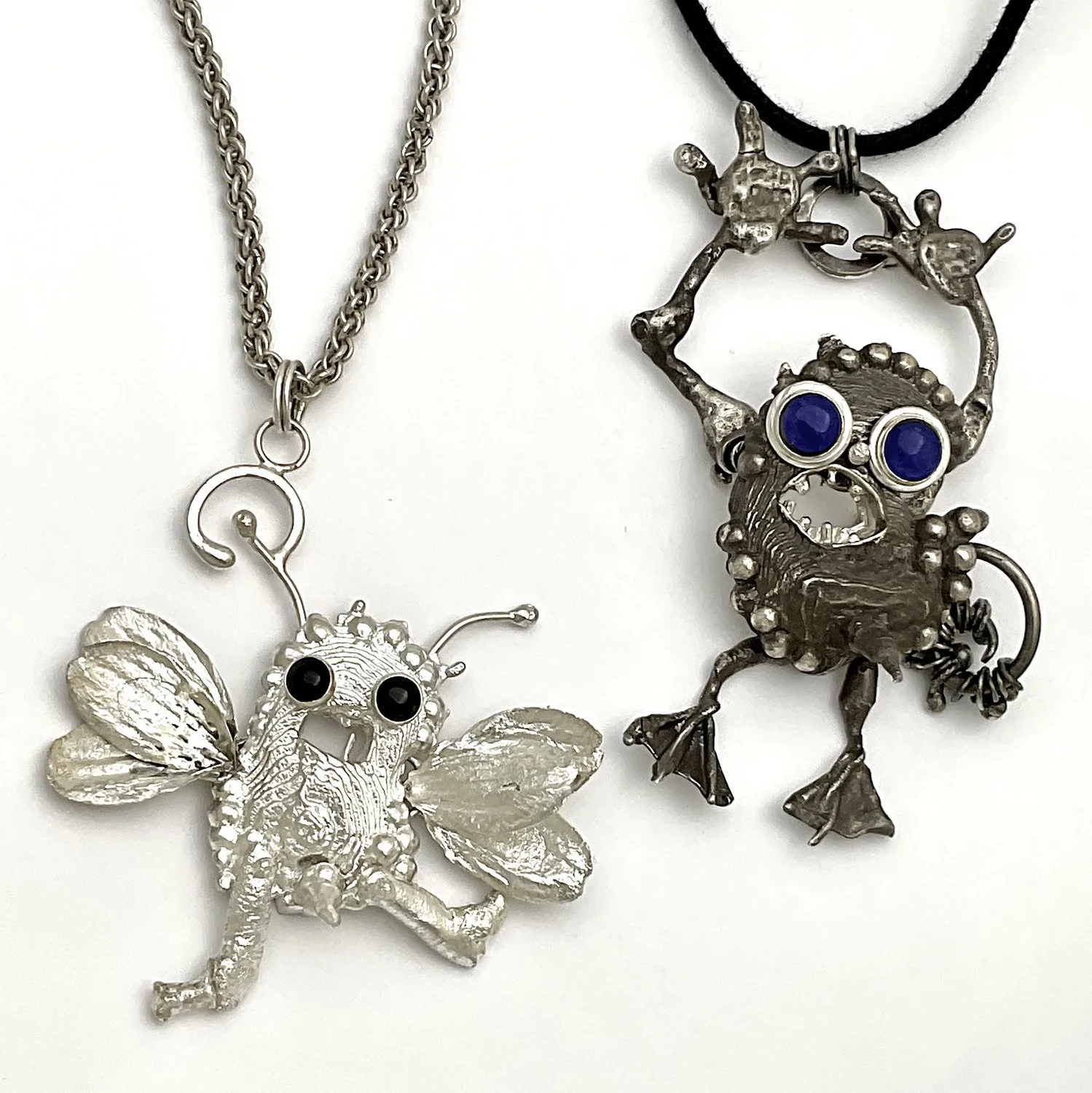 Two Sam Kramer inspired kinetic silver monsters