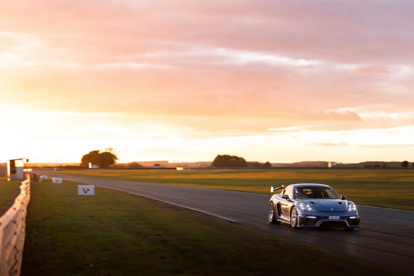 Porsche, on track at Snetterton, at sunset.