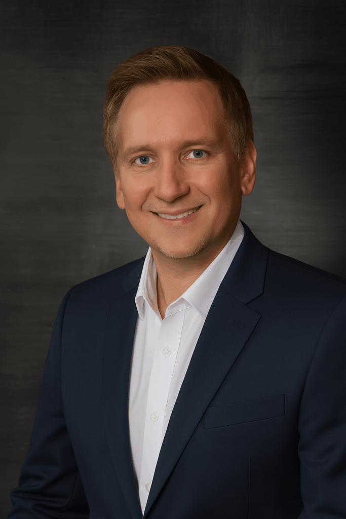 Professional headshot Mike Kimball, CFO, dressed in a dark suit and white shirt, against a dark background.