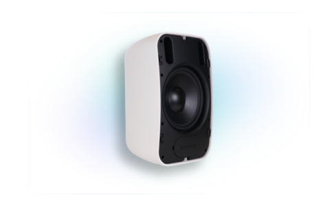 A white commercial speaker with a black front grill and a control knob on the top, standing on a colorful digital abstract background.