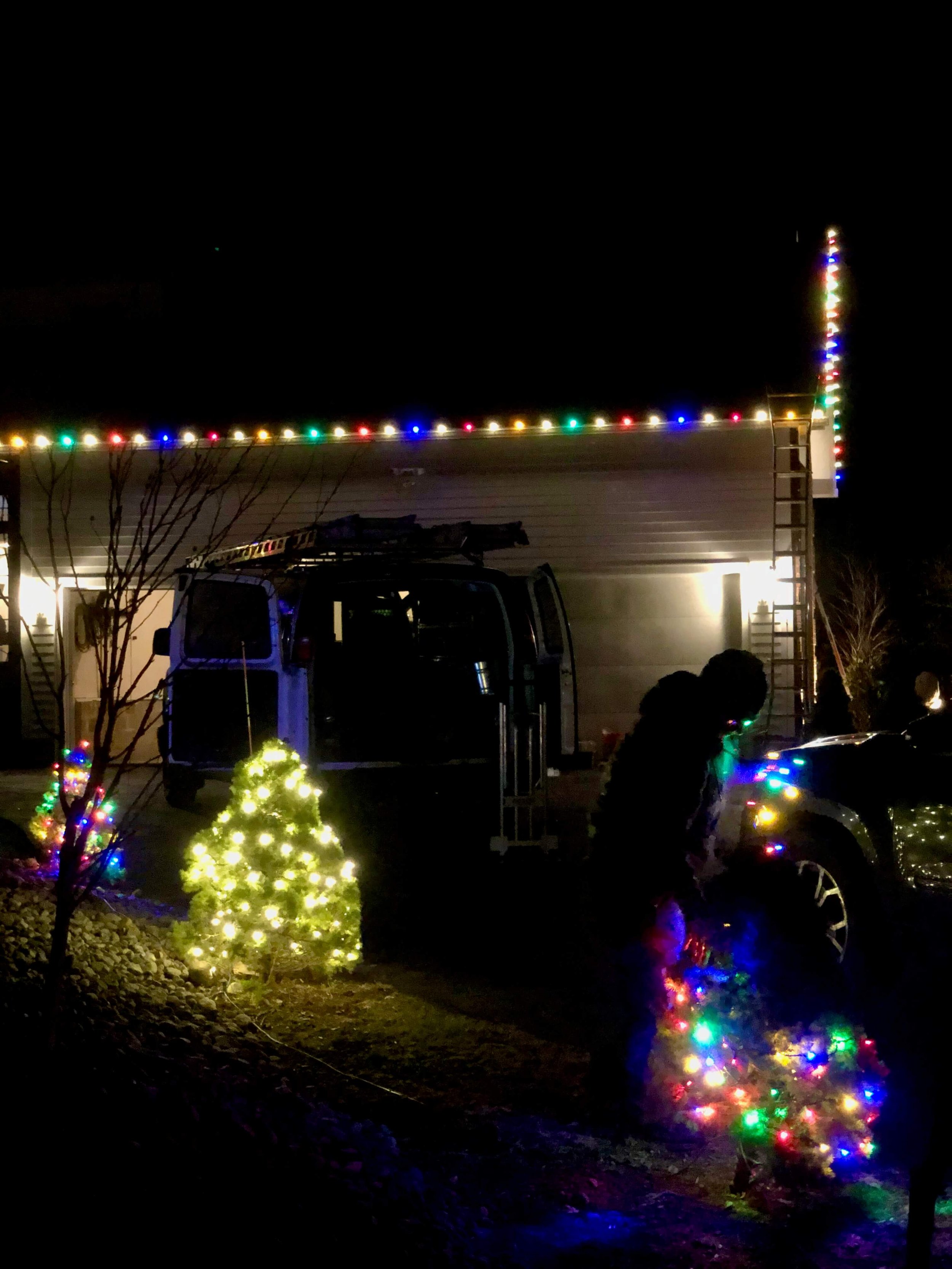 Long-time SHINE installer Tanner works overtime finishing a gumdrop-inspired Christmas lights installation with alternating use of warm white and multicolor pro-grade LED strings and custom C9 bulb lines on Braxton Circle, Fayetteville, NY in Dec 202