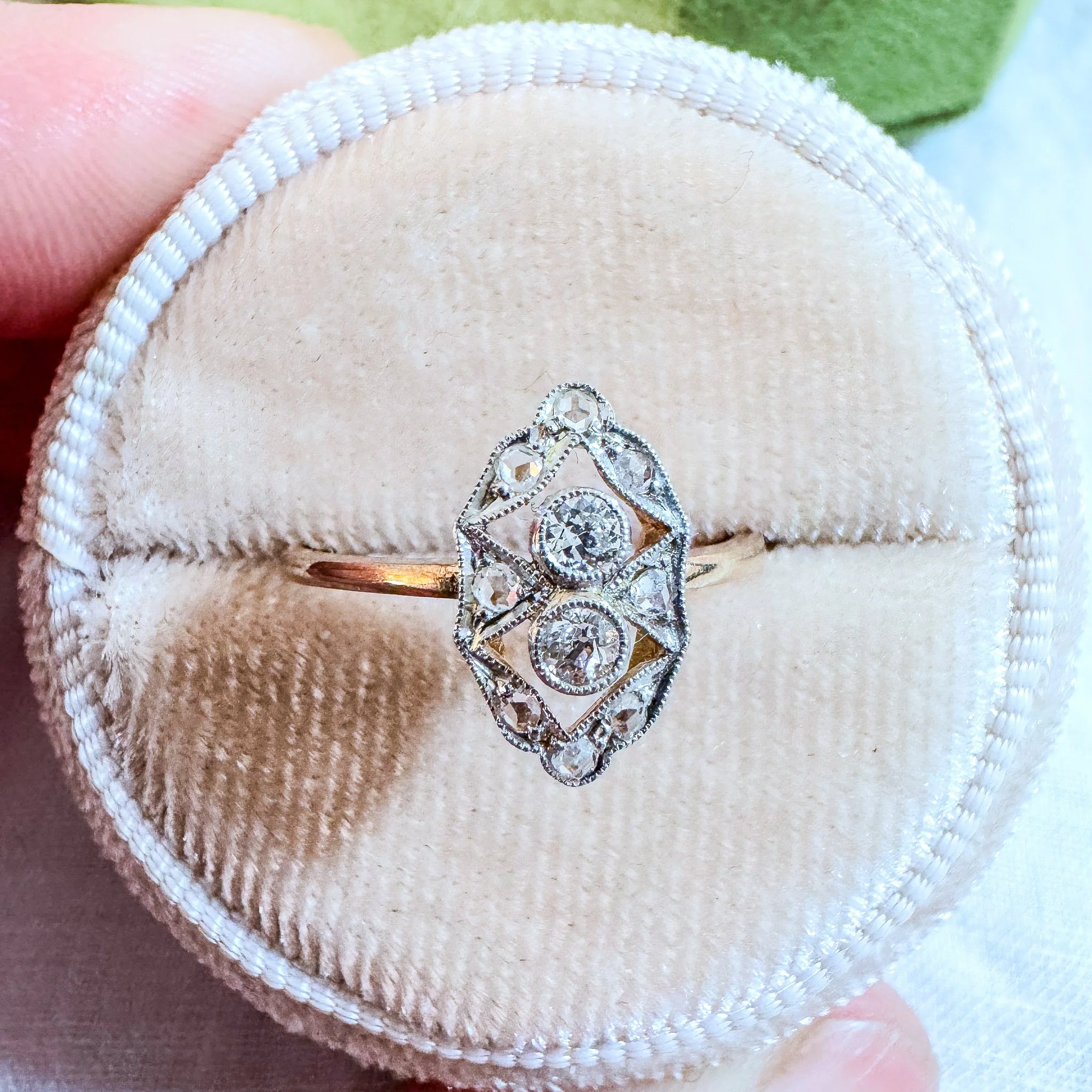 A diamond ring in a velvet ring box.