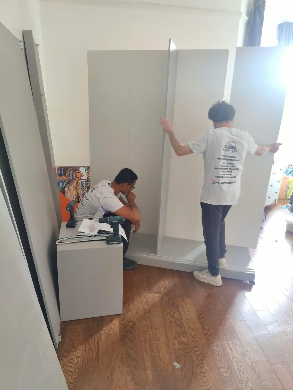 Wardrobe being taken apart by the crew from ready to go house movers and removals to be transported from West Hampstead to Hampstead Heath for a house moving job in North West London 