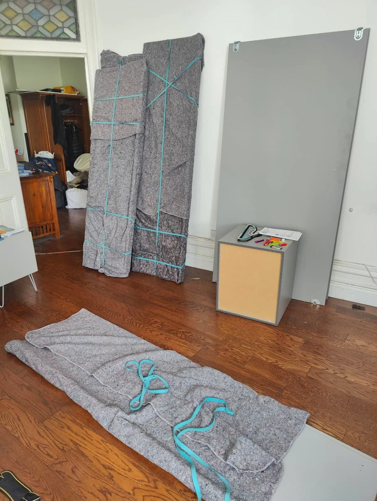 Wardrobe being protected with removal blankets for house move