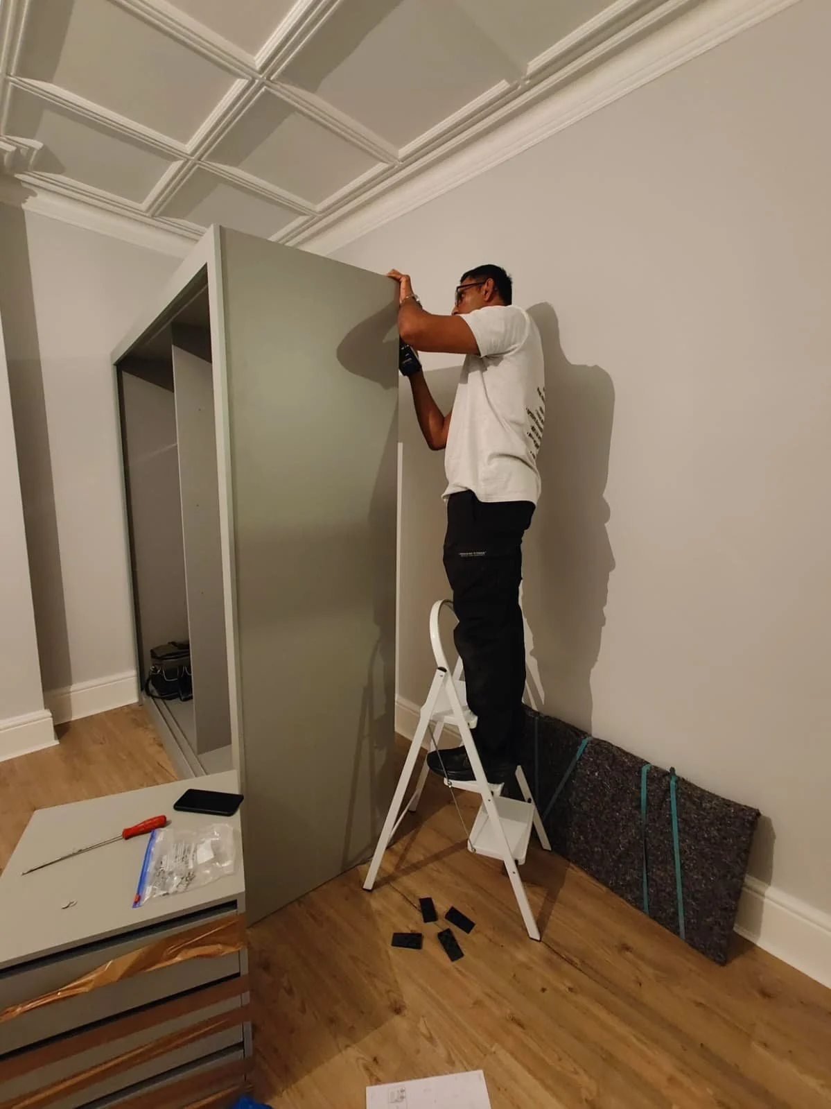 Sliding wardrobe door being reassembled 