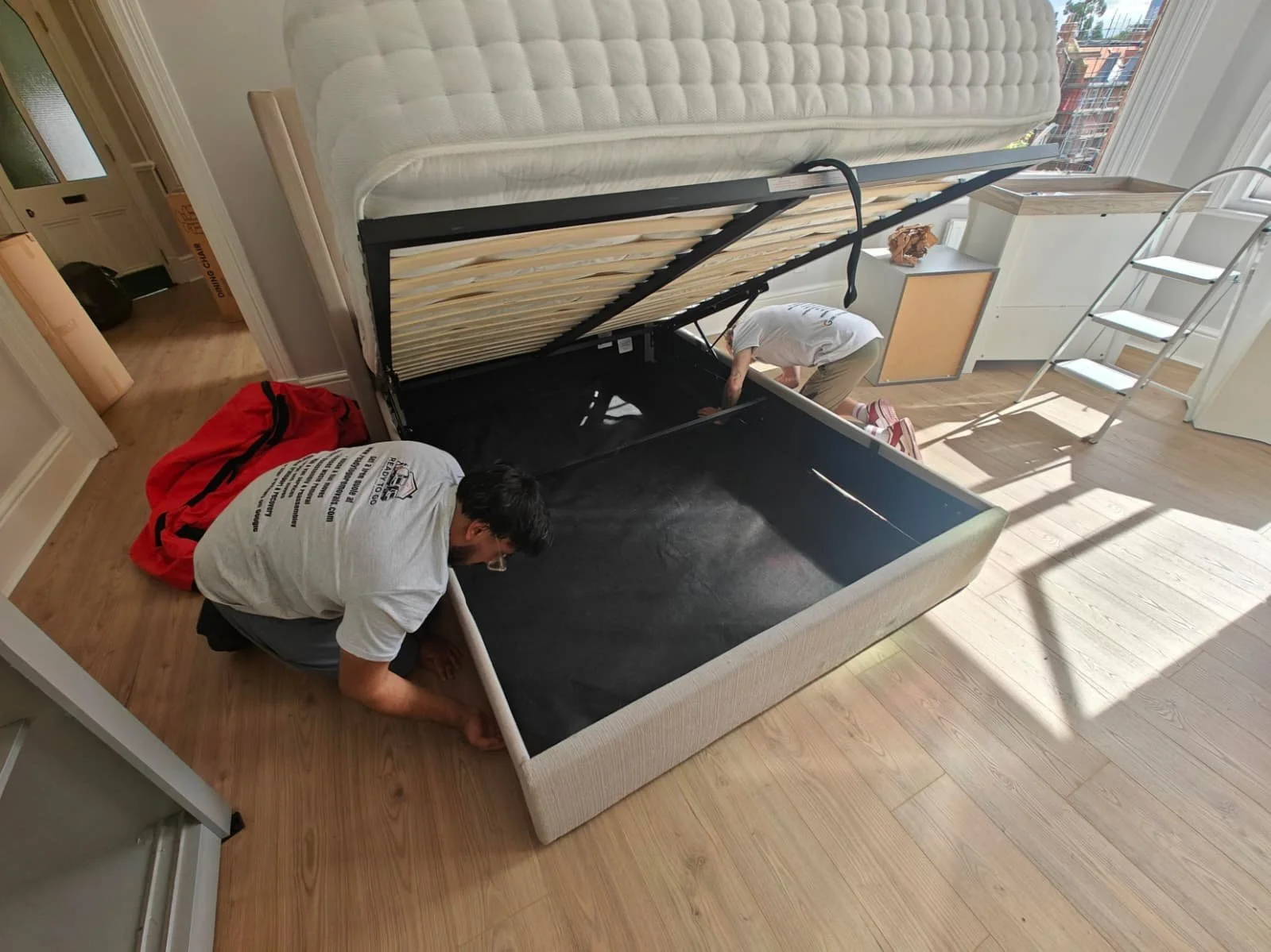 Ottoman bed being put back together by crew members from Ready To Go Removals
