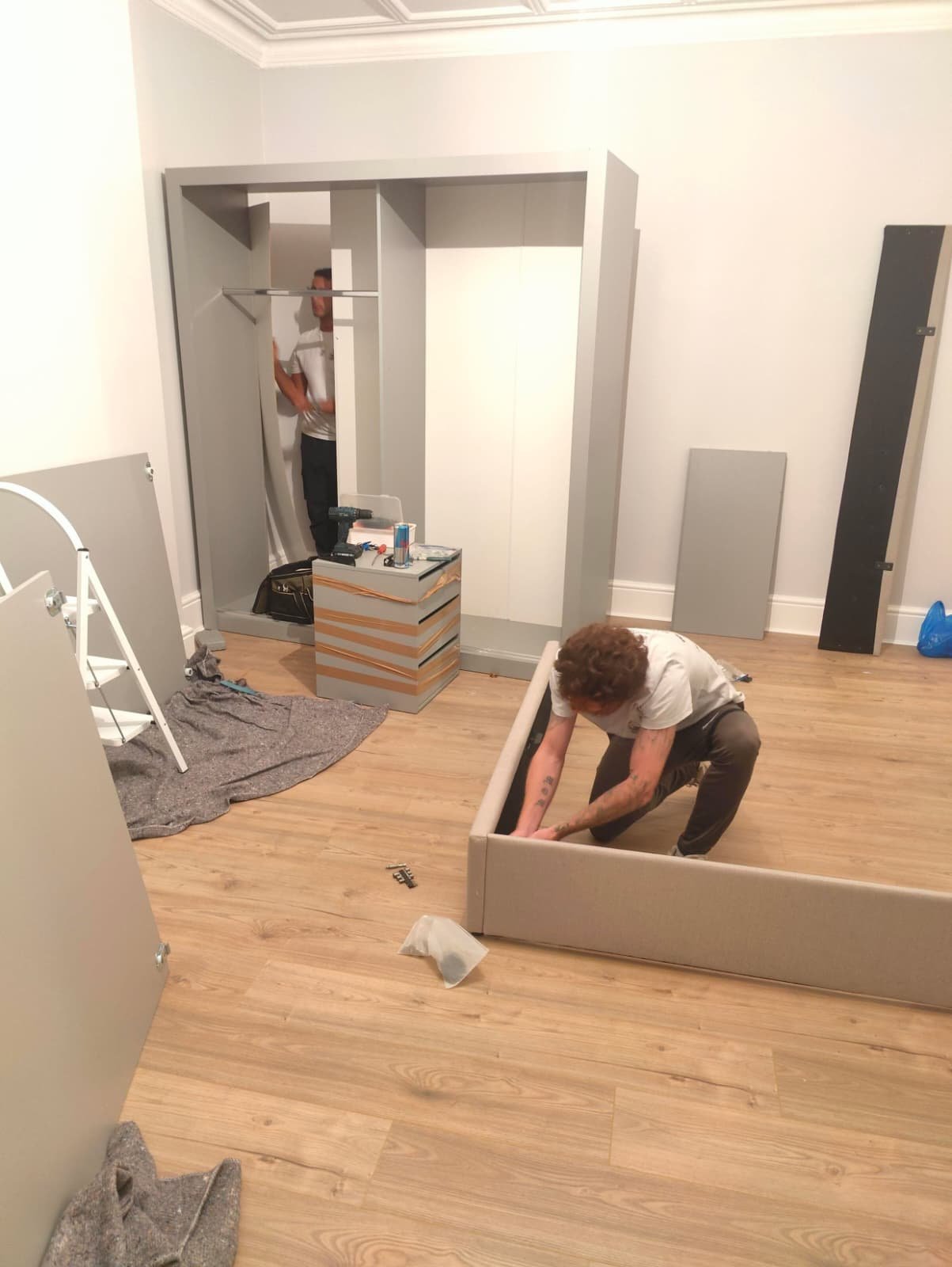 Wardrobe and bed being reassembled by 2 team members Ready To Go Removals