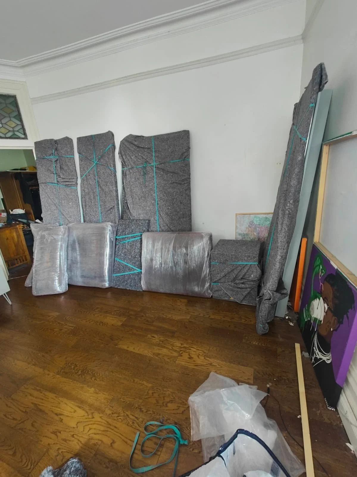 Wardrobe and sofa cushions wrapped and protected for house removal done by Ready To Go Removals