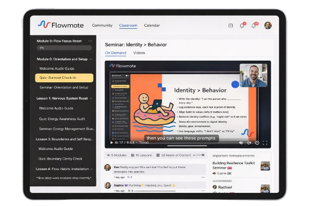 Screenshot of an educational online platform called Flowmote on a tablet, displaying a seminar titled 'Identity > Behavior' with a cartoon illustration, video controls, a sidebar menu of modules on psychology topics, and a chat section below the video.