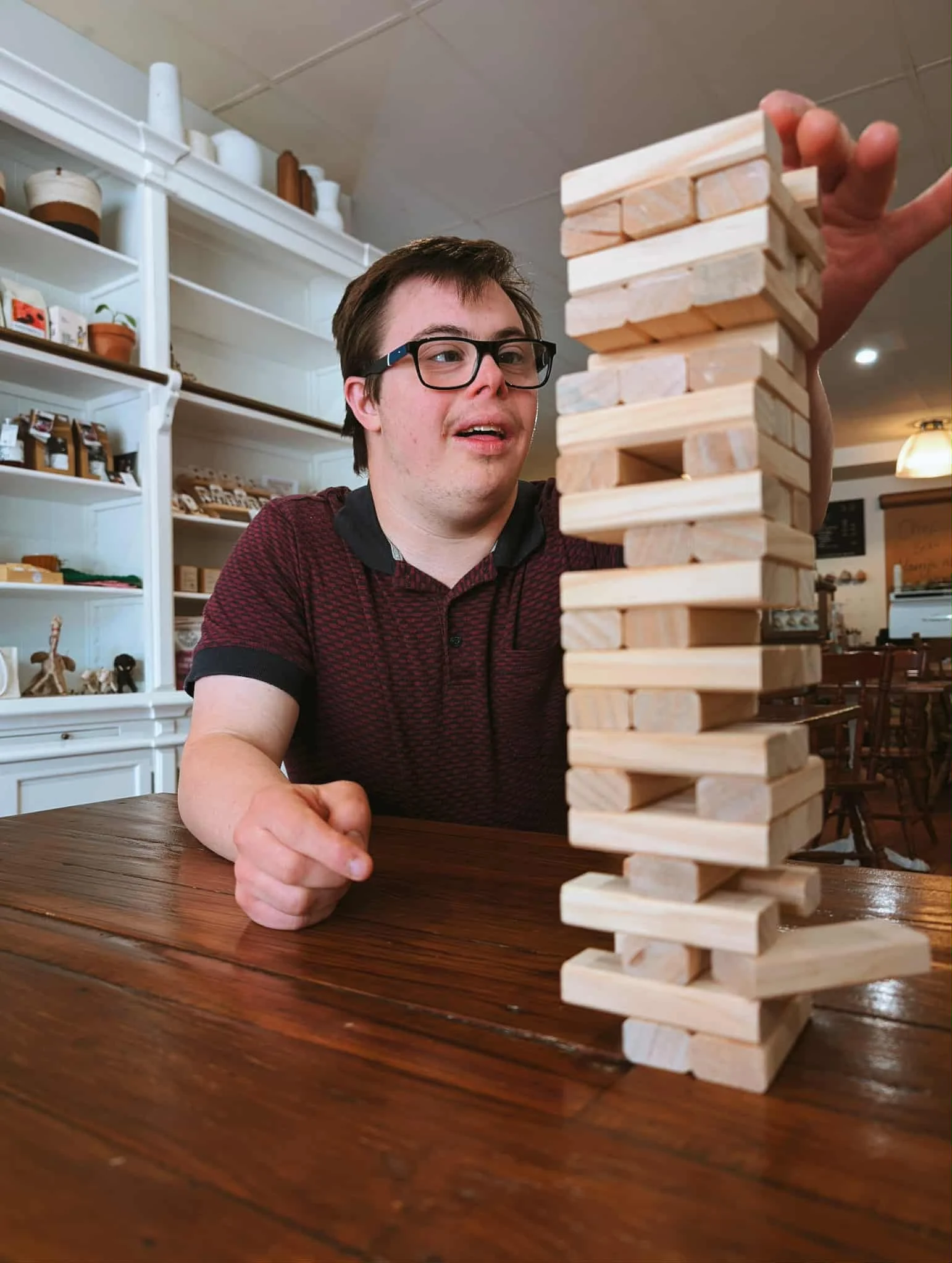 A couple playing a game with colorful game pieces on a table in a cozy living room.