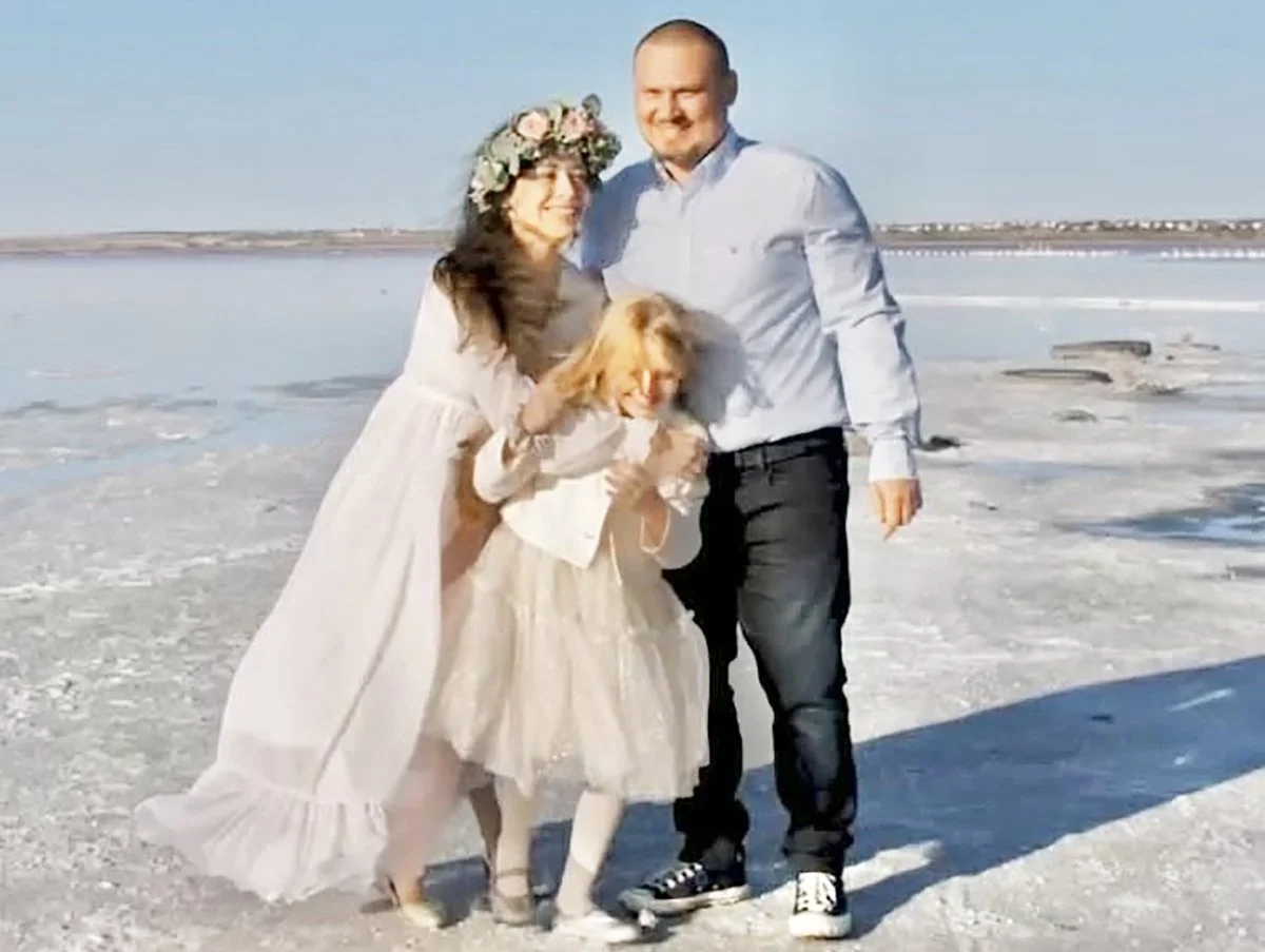 Yuriy, Maria and their daughter Miroslava pose in a family photo shoot. 