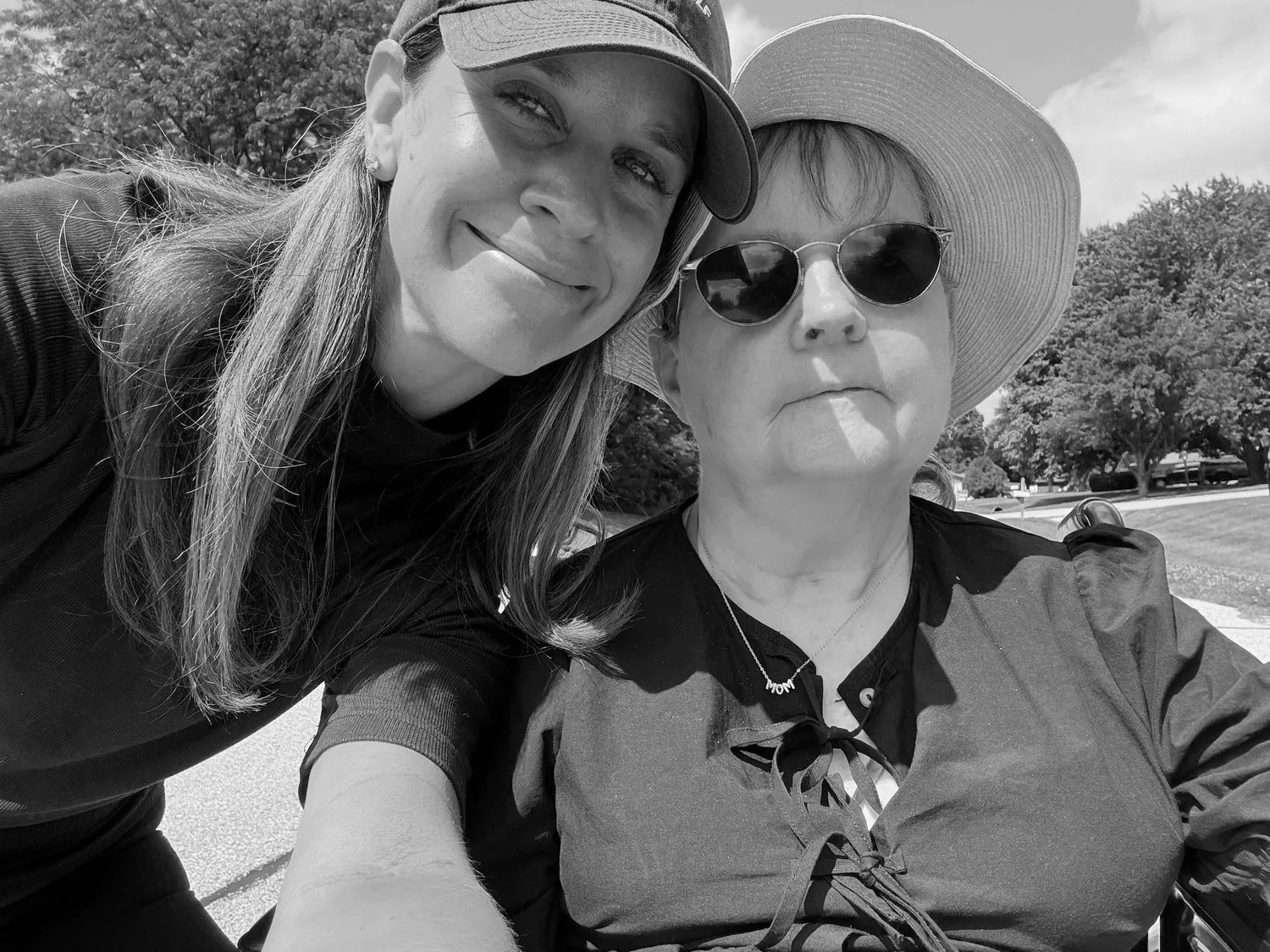 Laura and her mom together outdoors, wearing hats.