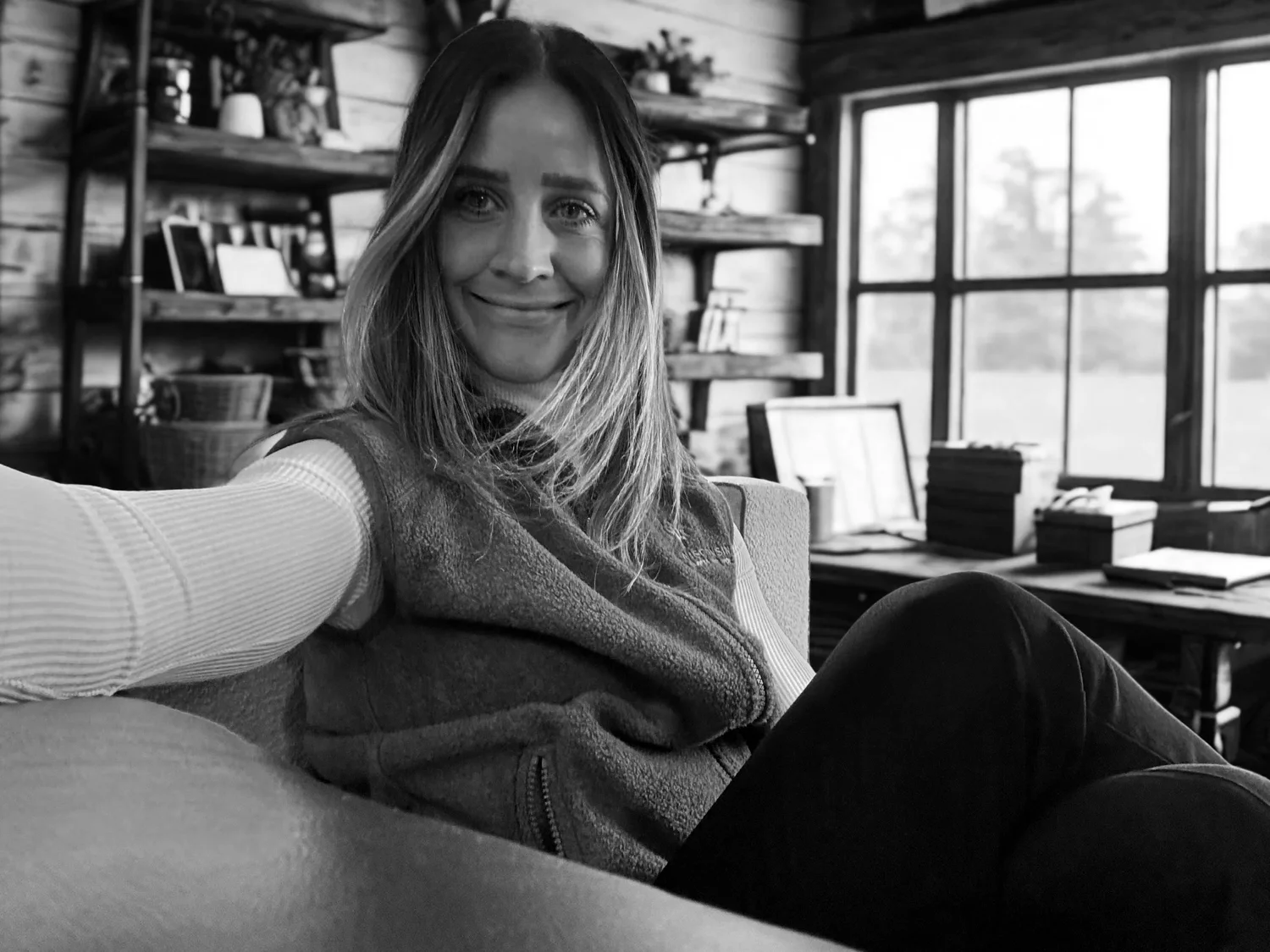 Laura seated indoors beside a window.