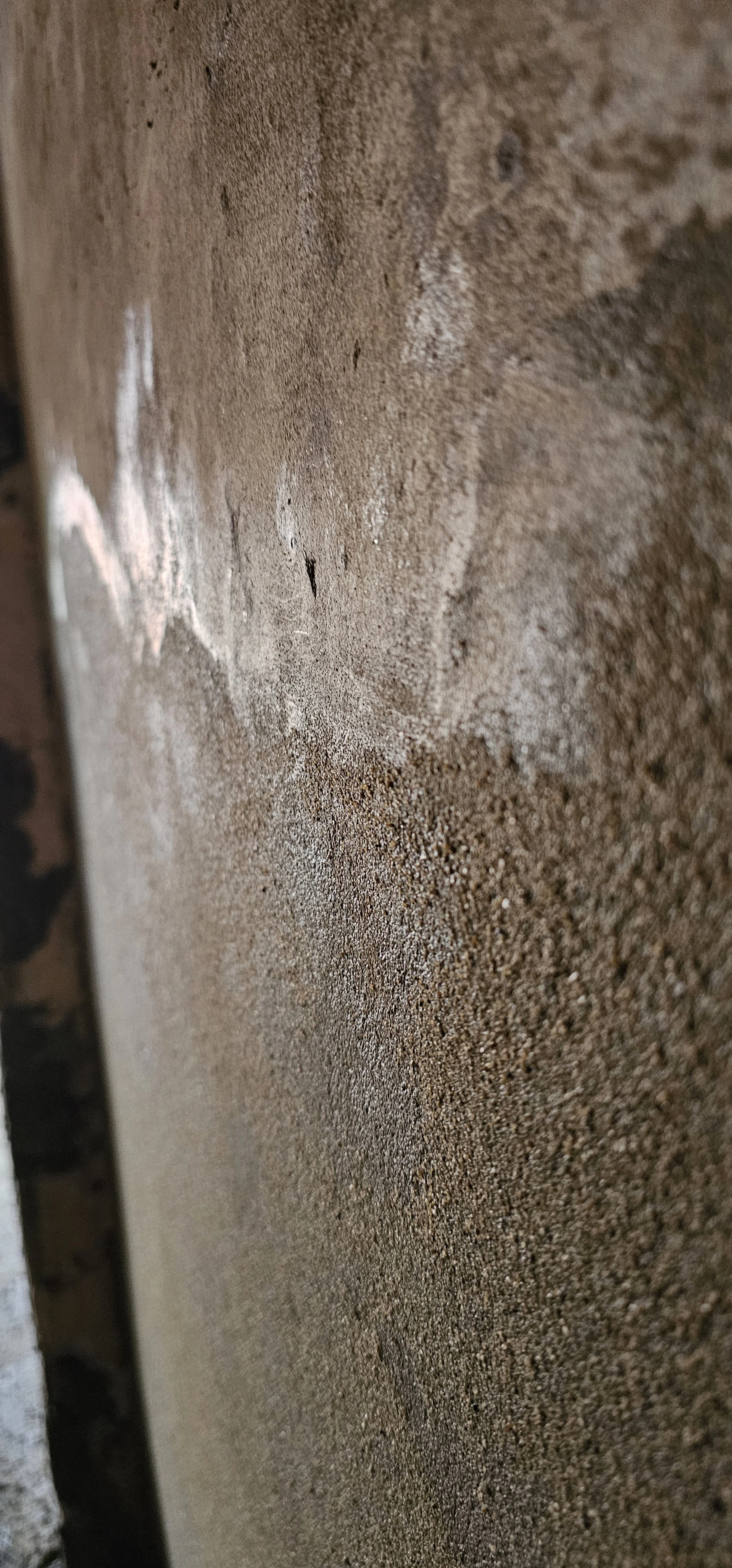 Close-up view of a sand and cement render patch