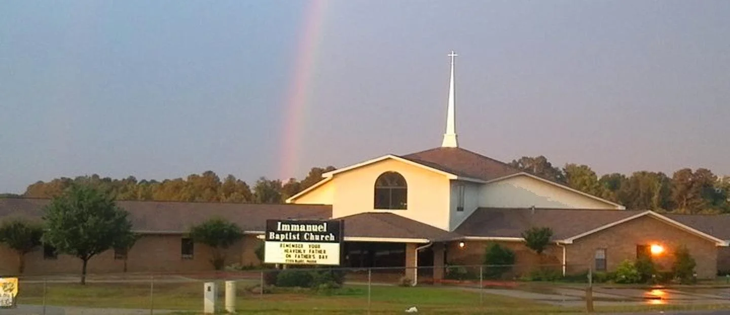 A church with a rainbow in the background