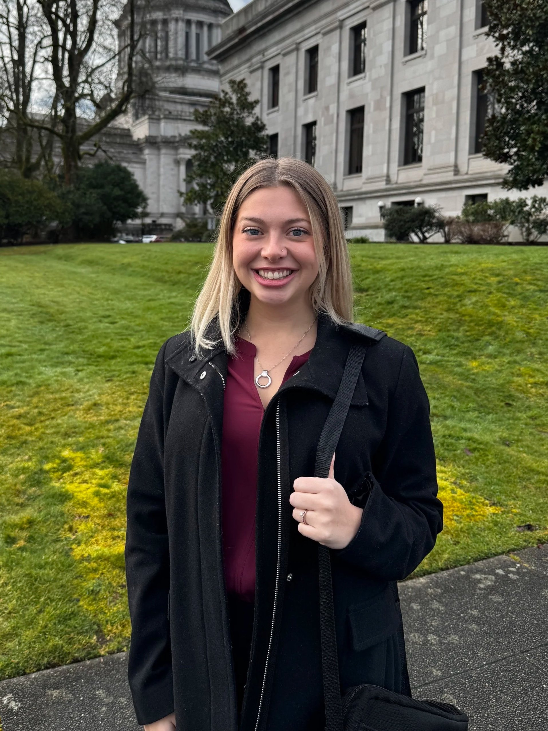 Washington State Business and Healthcare Lobbyist Abbey Smelcer in front of the Olympia Capitol Building