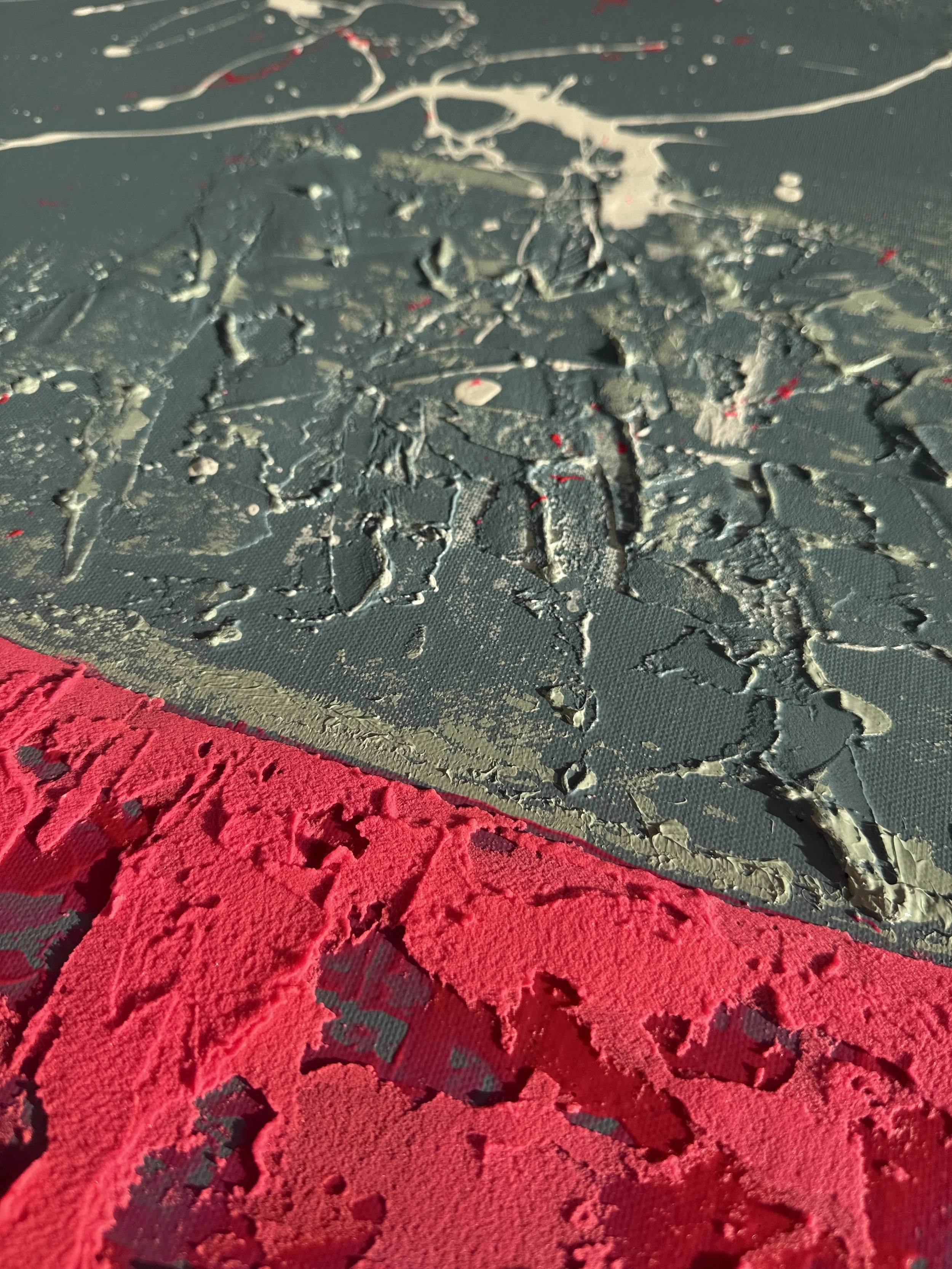 Close-up d'une surface texturée avec de la peinture craquelée noire et rouge.