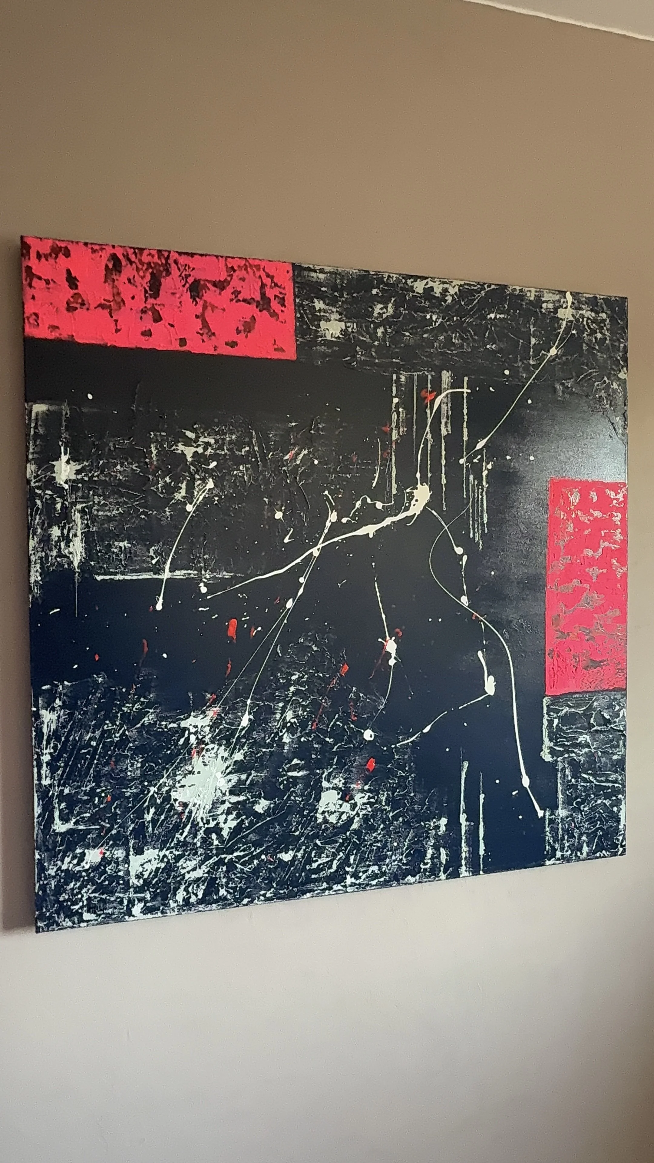 Peinture abstraite avec des éclaboussures de blanc et de rouge sur un fond noir, avec des rectangles roses en haut à gauche et en bas à droite.