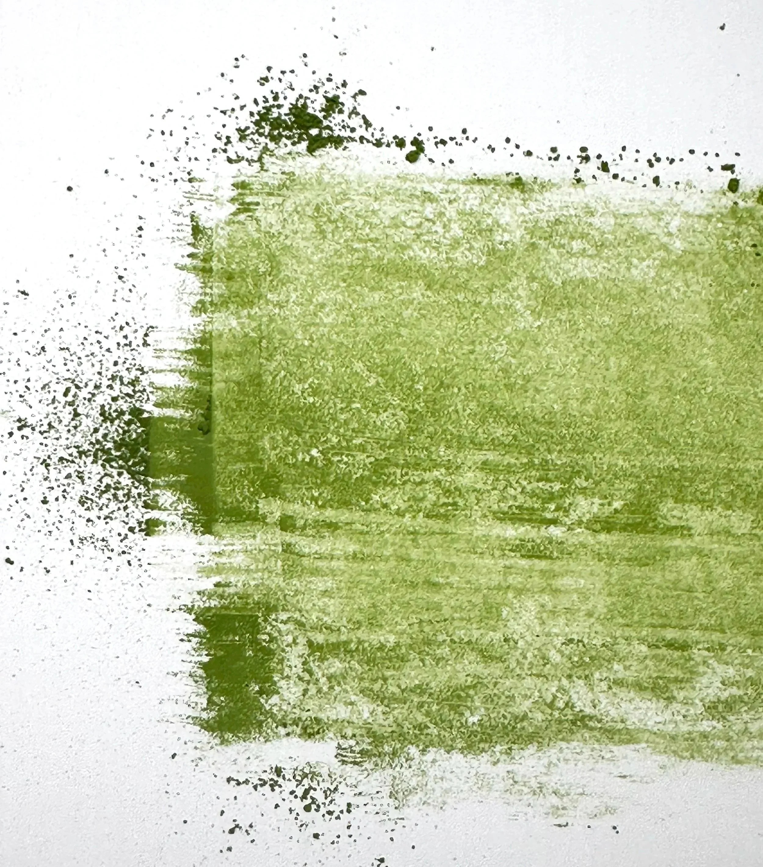 Abstract watercolor painting with green hues and black specks on white background.
