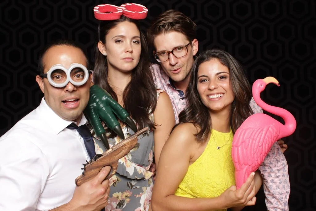 Wedding guests pose in a Calgary photo booth