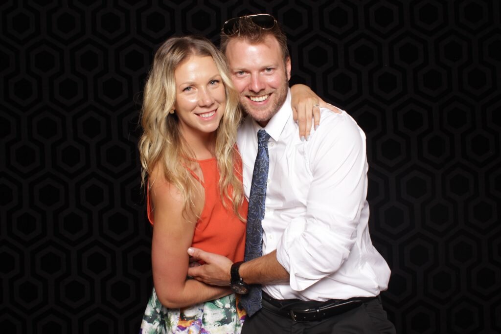A cute couple poses for a photo in a Calgary wedding photo booth