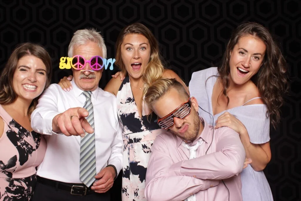 Wedding guests pose for a photo in a Calgary wedding photo booth