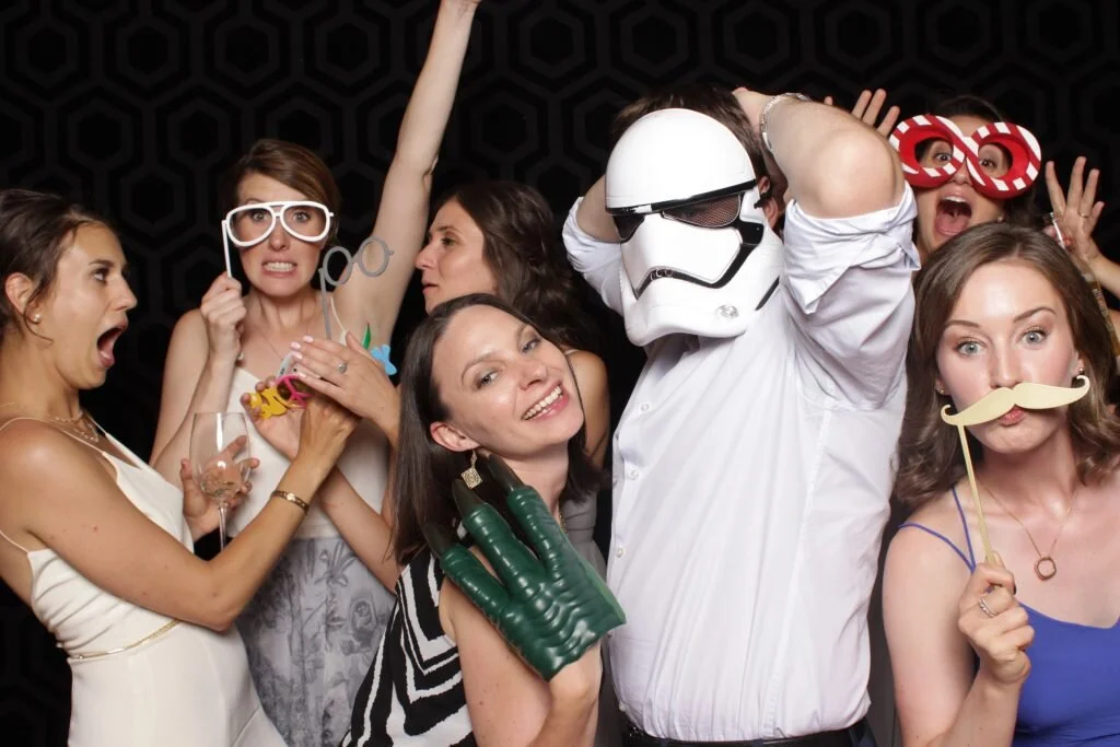 Wedding guests pose for a photo in a Calgary wedding photo booth
