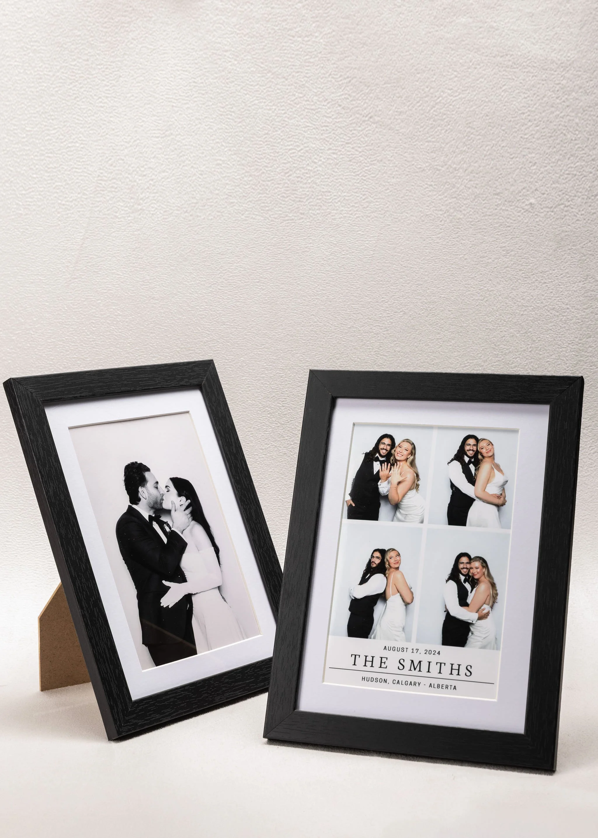 Two black picture frames displaying wedding photos of a couple, with the right frame showing a four-photo collage and the left frame showing a black and white photo of the couple kissing.