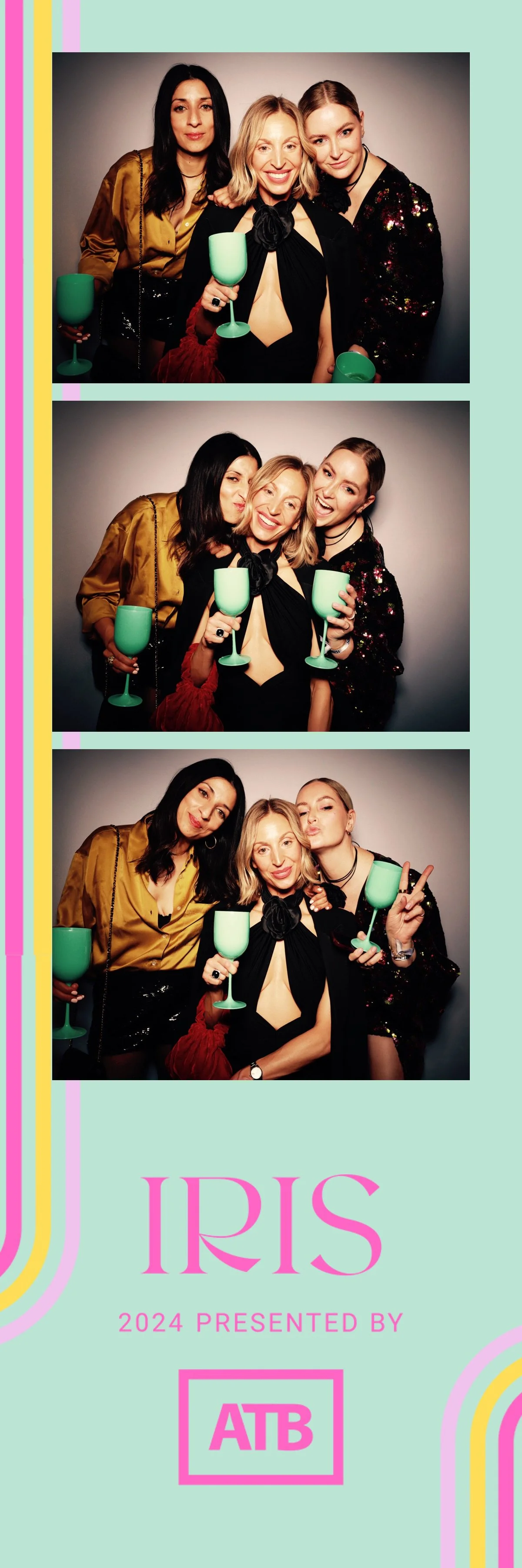 Three women at the IRIS 2024 event posing with drinks in a photo booth, with the event logo and branding on a pastel background.