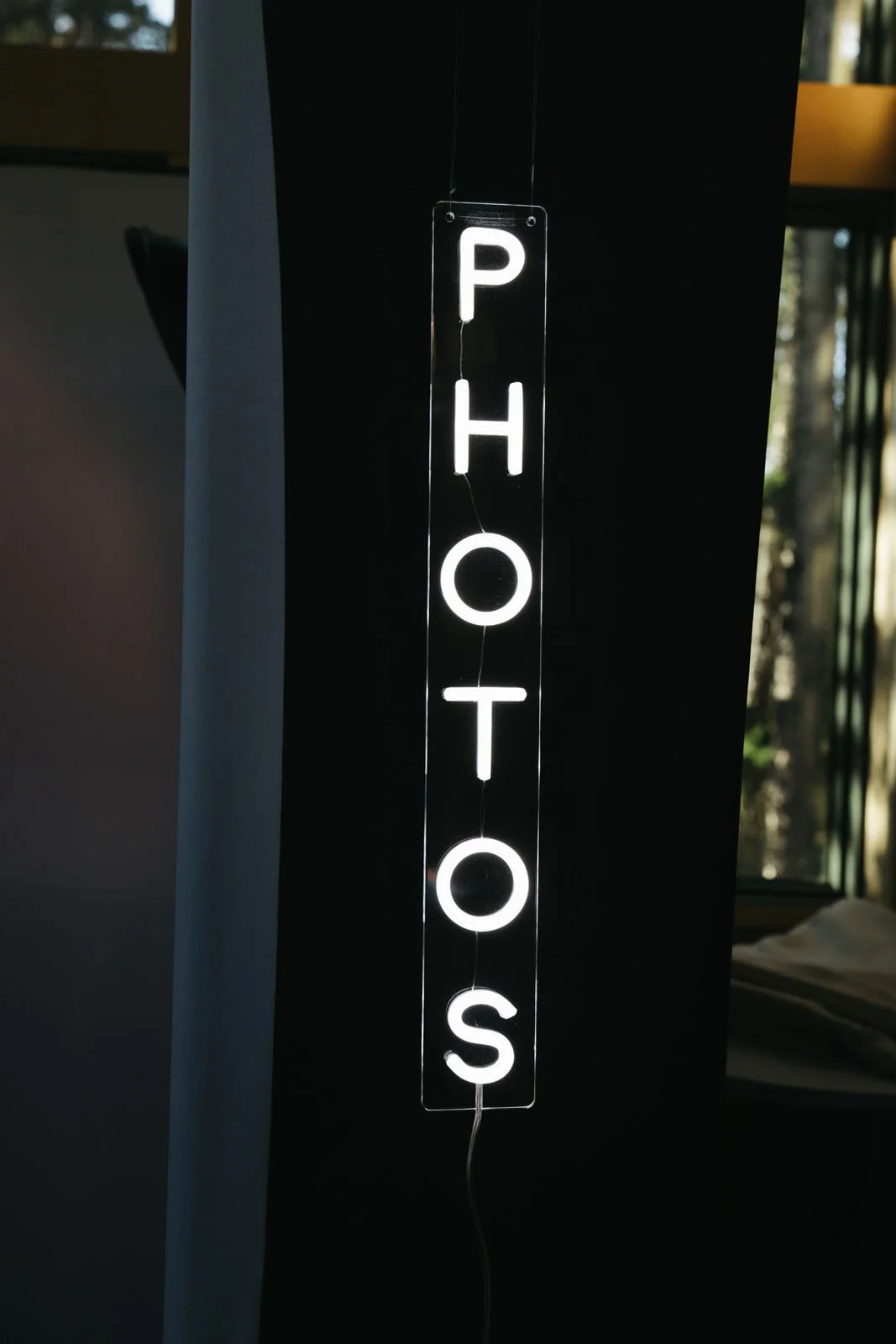 Neon sign that reads 'PHOTO' vertically.
