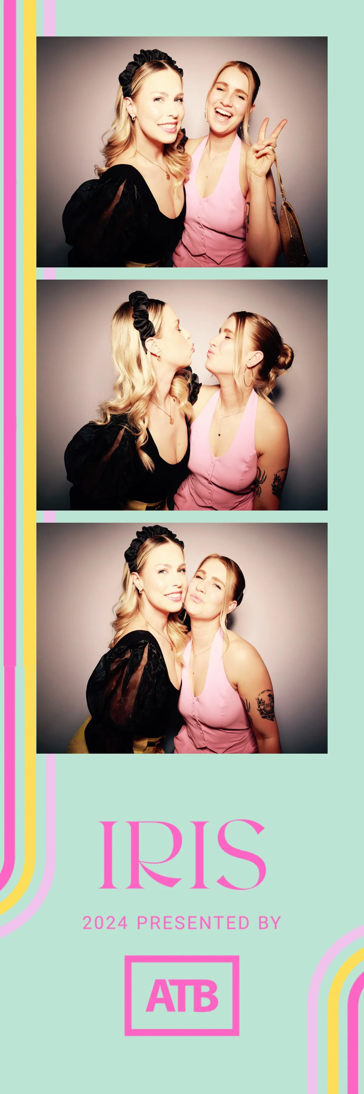 Photobooth strip with three images of two women, one with blonde hair and black outfit, and the other with brown hair in a pink dress. They are posing playfully, kissing, and smiling at the camera, with a light gray background. The photobooth strip f